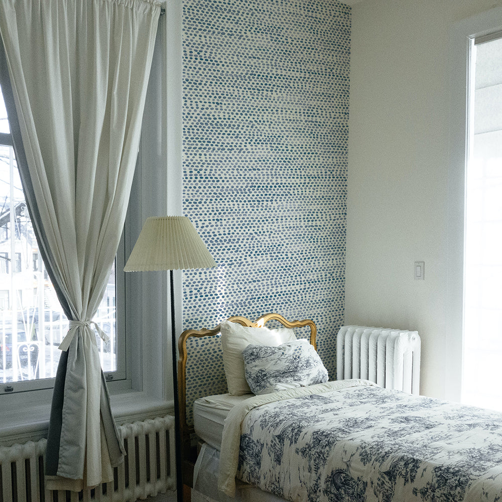 Moire Dots Removable Wallpaper - A bed and white radiators in a bedroom featuring Tempaper's Moire Dots Peel And Stick Wallpaper in blue moon dots | Tempaper#color_blue-moon-dots