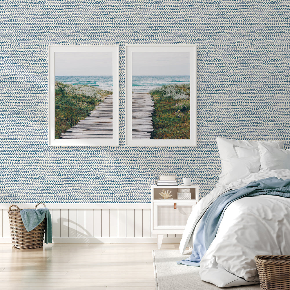 Moire Dots Removable Wallpaper - A bedroom with a bed, white nightstand, and two pictures in front of a wall featuring Tempaper's Moire Dots Peel And Stick Wallpaper in blue moon dots | Tempaper#color_blue-moon-dots