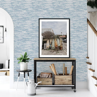 Moire Dots Removable Wallpaper - A black cart, white and black small table, and a picture in front of a wall featuring Tempaper's Moire Dots Peel And Stick Wallpaper in blue moon dots | Tempaper#color_blue-moon-dots