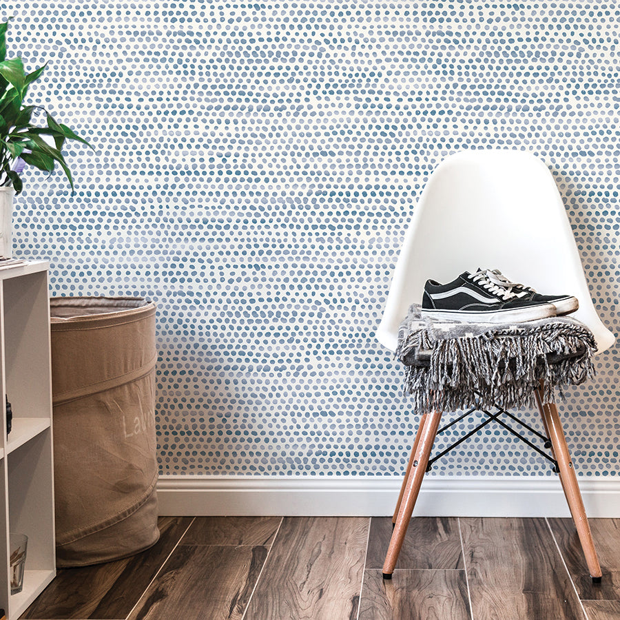 Moire Dots Removable Wallpaper - A white chair and white shelves in front of a wall featuring Tempaper's Moire Dots Peel And Stick Wallpaper in blue moon dots | Tempaper#color_blue-moon-dots