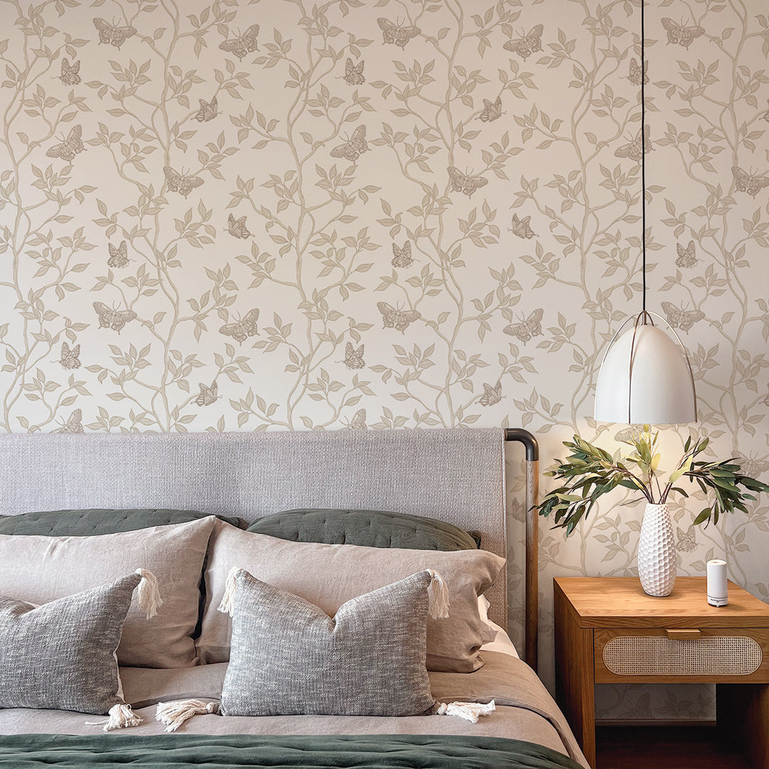 Monarch Non-Pasted Wallpaper - A bedroom with a bed and wood nightstand featuring Monarch Unpasted Wallpaper in fawn | Tempaper#color_fawn