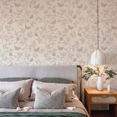 Monarch Non-Pasted Wallpaper - A bedroom with a bed and wood nightstand featuring Monarch Unpasted Wallpaper in fawn | Tempaper#color_fawn