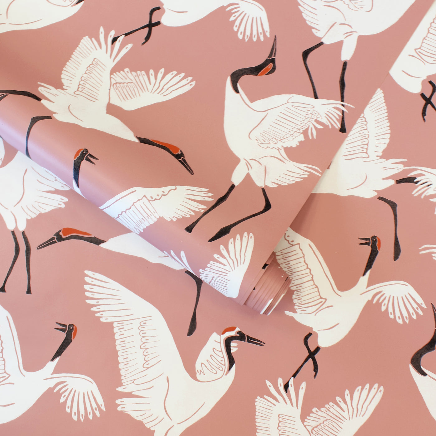 A roll of Tempaper's Family of Cranes Peel And Stick Wallpaper By Novogratz.