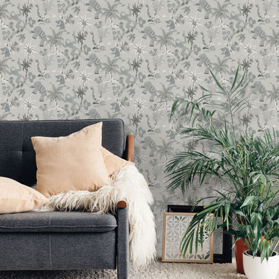 Monkey Business Removable Wallpaper By Novogratz - A grey couch with beige throw pillows and a couple of plants in a room featuring Monkey Business Peel And Stick Wallpaper By Novogratz in forest fog | Tempaper#color_forest-fog