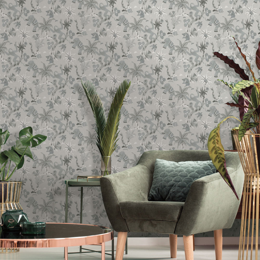Monkey Business Removable Wallpaper - Tempaper's Monkey Business peel and stick wallpaper in forest fog on the wall of living room with a dark green chair, a copper coffee table, and green plants | Tempaper#color_forest-fog