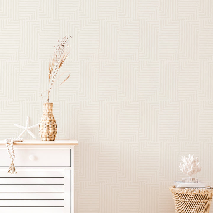 A white dresser in front of Tempaper's Geometric Patchwork Removable Wallpaper.