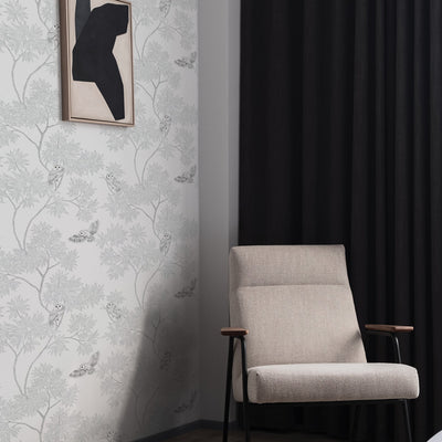 Parliament Non-Pasted Wallpaper - A grey chair and black curtain with Parliament Unpasted Wallpaper in snow white | Tempaper#color_snow-white