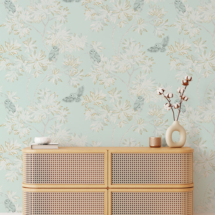 Parliament Non-Pasted Wallpaper - A tan dresser and a plant with Parliament Unpasted Wallpaper in celeste | Tempaper#color_celeste