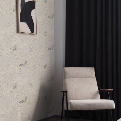 Parliament Non-Pasted Wallpaper - A grey chair and black curtain with Parliament Unpasted Wallpaper in natural beige | Tempaper#color_natural-beige