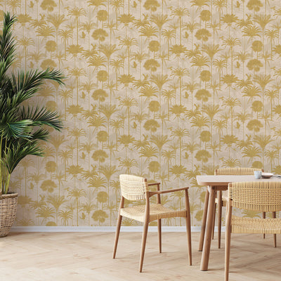A wood table and plant in front of Tempaper's Royal Palm Peel And Stick Wallpaper.