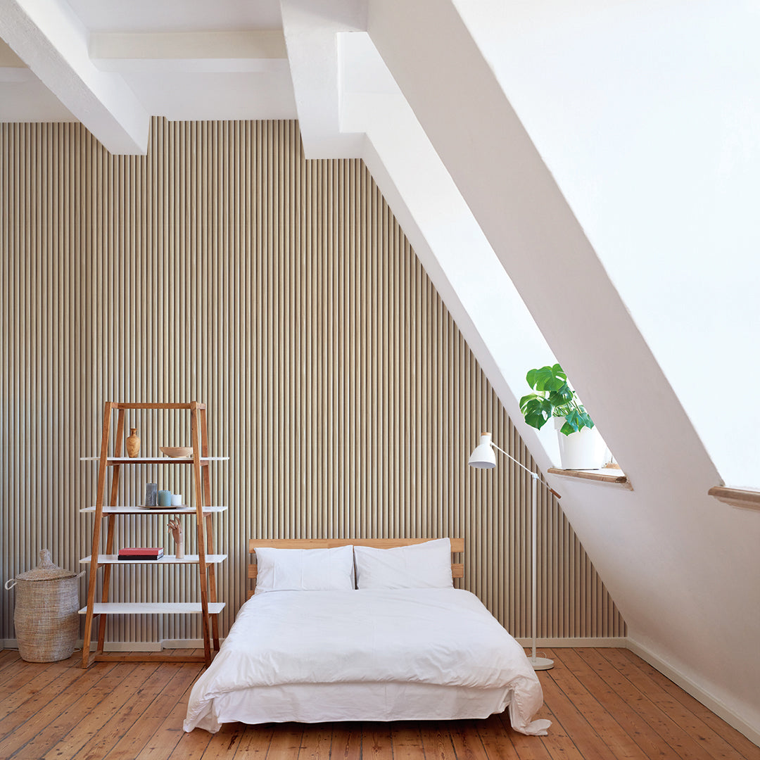Reeded Wood peel and stick wallpaper in a bedroom displayed behind a bed.
