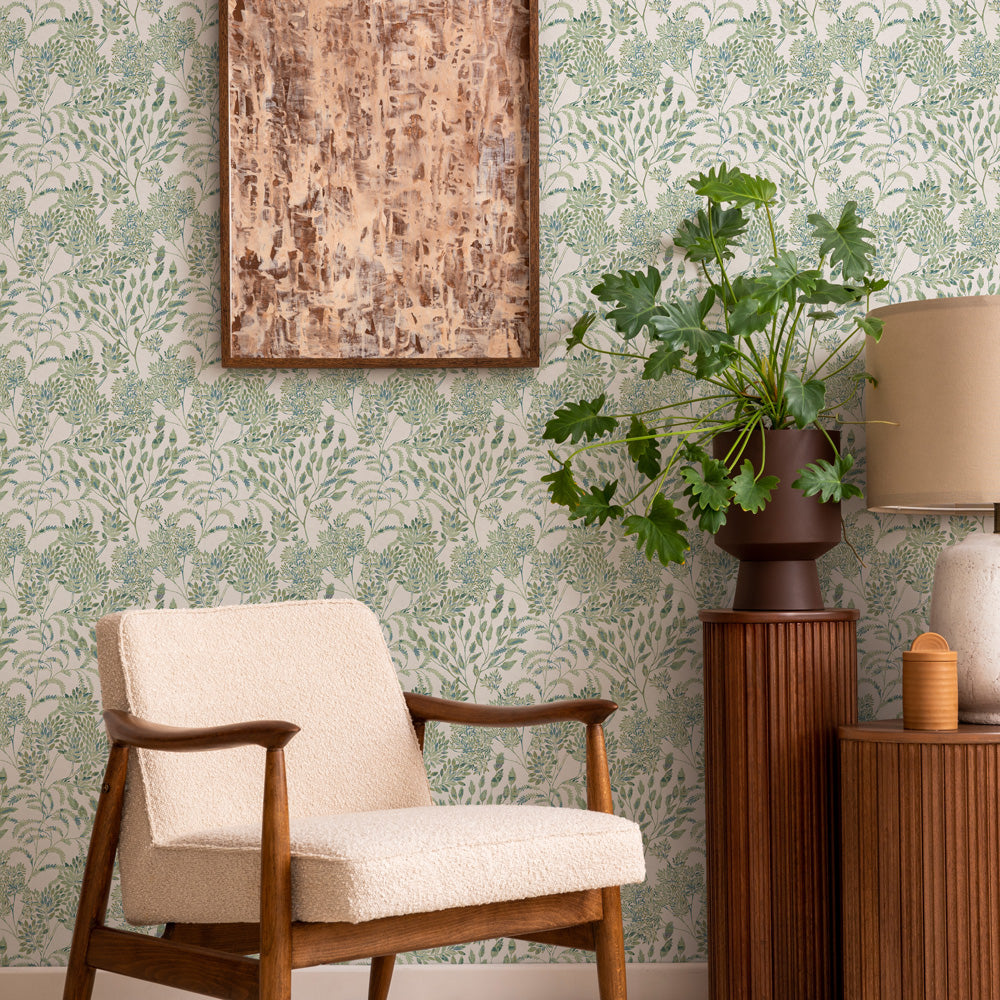 Stencil Foliage Non-Pasted Wallpaper - A chair and plant in front of Stencil Foliage Unpasted Wallpaper in eucalyptus | Tempaper#color_eucalyptus
