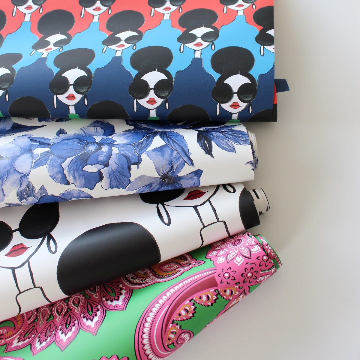 Rolls of Tempaper's Removable Wallpaper Alice + Olivia Collection