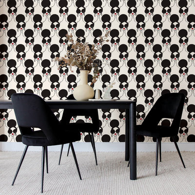 A black table with three black chairs and Tempaper's XOXO Stace Peel And Stick Wallpaper By Alice + Olivia.