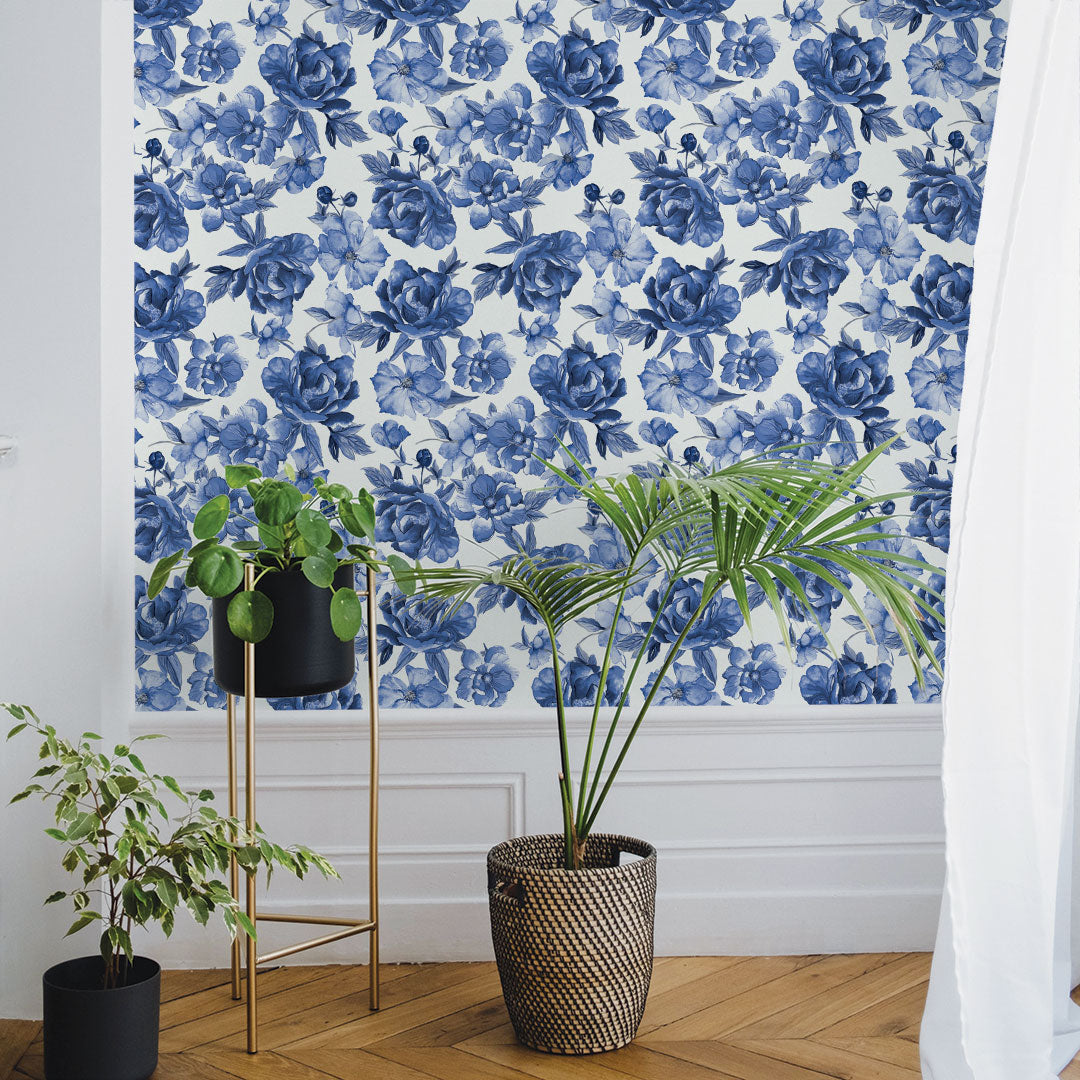 Tempaper's Forget-Me-Not Peel And Stick Wallpaper By Alice + Olivia shown behind plants.
