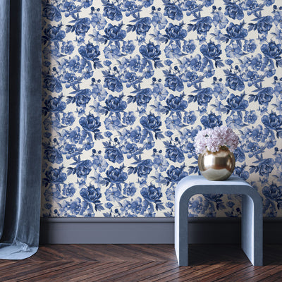 Tempaper's Forget-Me-Not Peel And Stick Wallpaper By Alice + Olivia shown behind a table and plant.