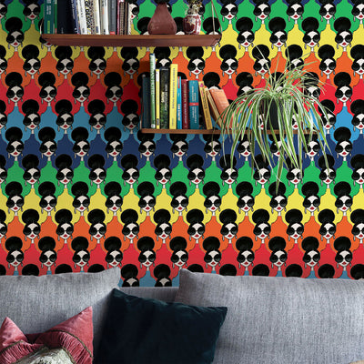 A grey couch and wood shelves with Tempaper's Rainbow Stace Peel And Stick Wallpaper By Alice + Olivia.