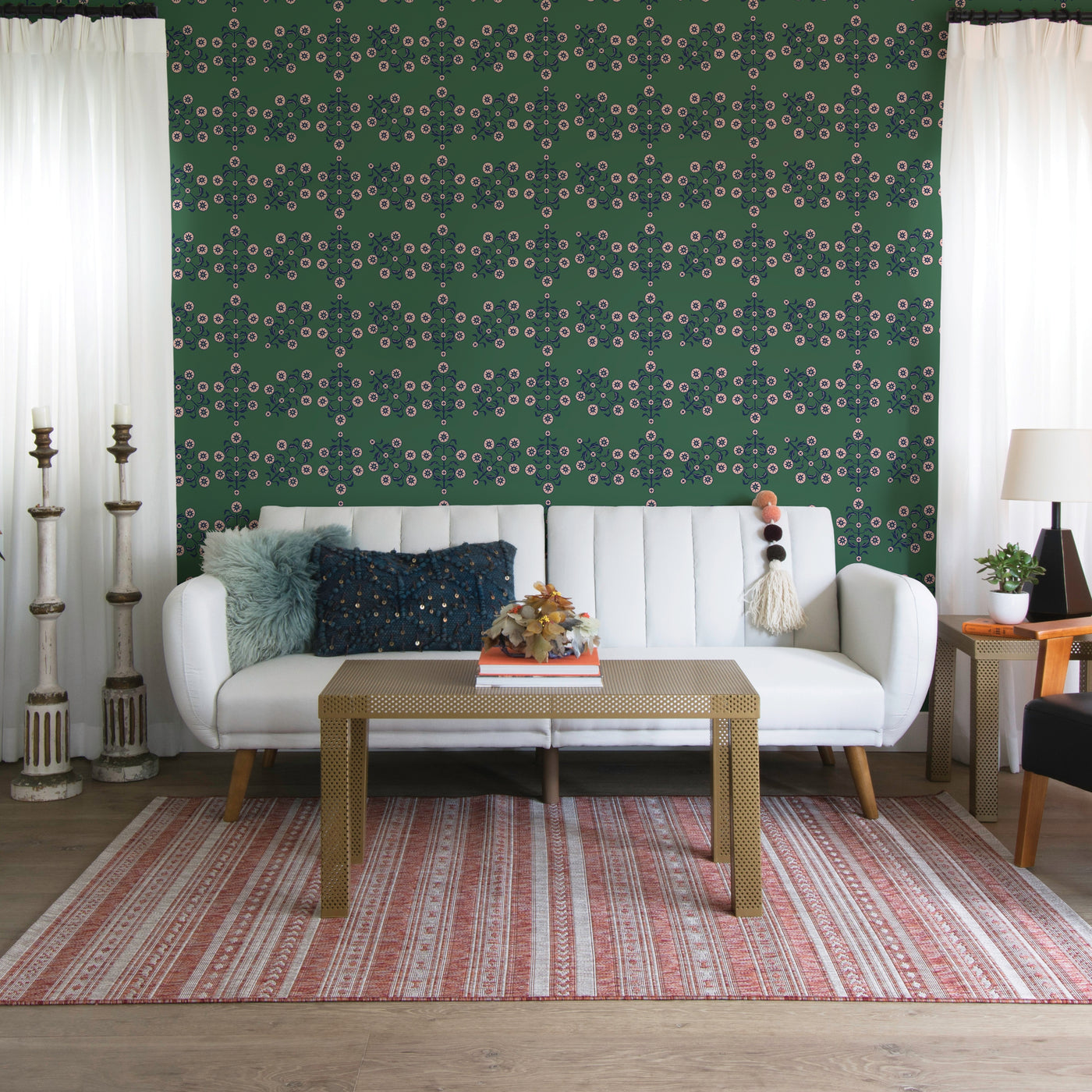 Block Print Floral WALLPAPER in green displayed in a living room behind a couch.