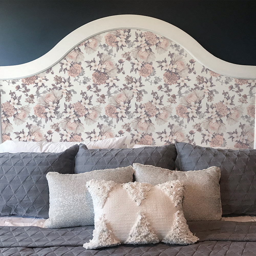 Botanical WALLPAPER displayed on a headboard behind a bed.