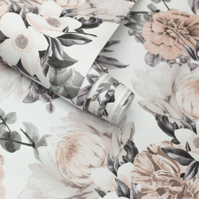 A slightly unraveled roll of Botanical WALLPAPER in mauve pink.