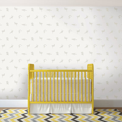 Breakers peel and stick wallpaper in a white and grey colorway displayed in a nursery behind a yellow crib.