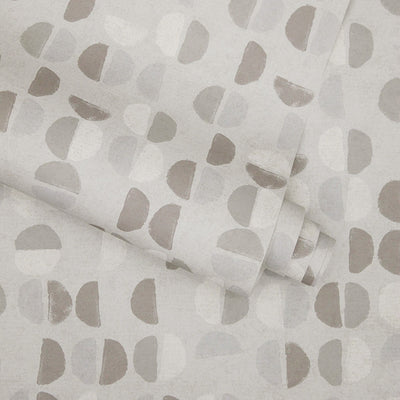 A slightly unraveled roll of Tempaper's Coffee Beans Peel And Stick Wallpaper in grey.