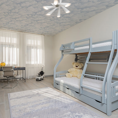 Tempaper's Clouds Peel And Stick Wall Mural in light blue shown on a ceiling in a kids room.