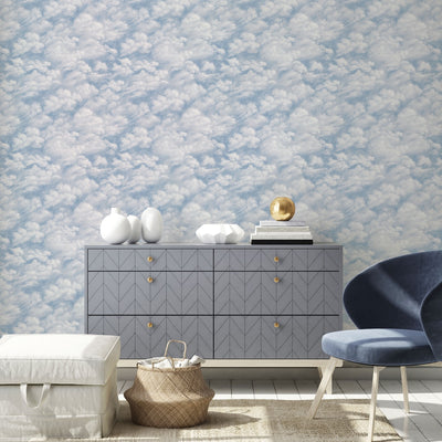 Tempaper's Clouds Peel And Stick Wall Mural in light blue shown behind a dresser.