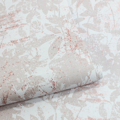 A slightly unraveled roll of Tempaper's Garden Floral Peel And Stick Wallpaper.