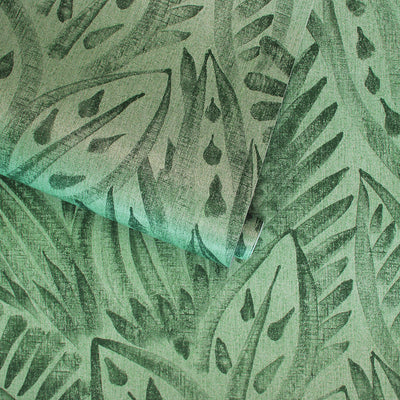 A slightly unraveled roll of Canvas peel and stick wallpaper in a dark green colorway.