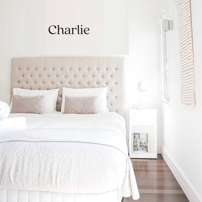 Tempaper's Charlie custom name wall decal in black shown in a bedroom.#color_black