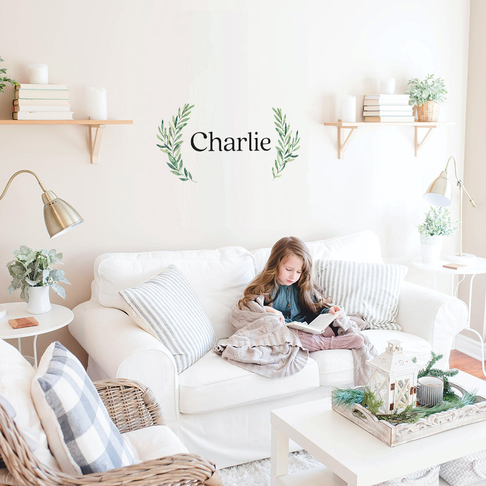 Tempaper's Charlie custom name wall decal in black and green behind a couch.#color_black