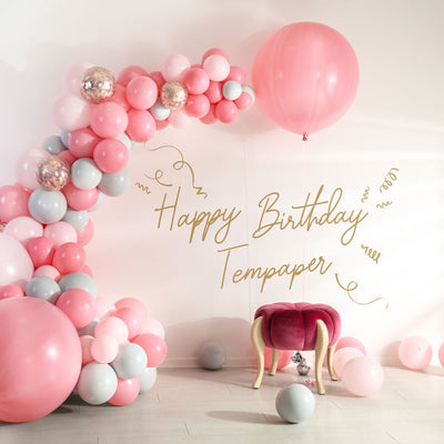 Tempaper's Custom Happy Birthday Wall Decal with "Happy Birthday Tempaper" as an example shown below balloons.