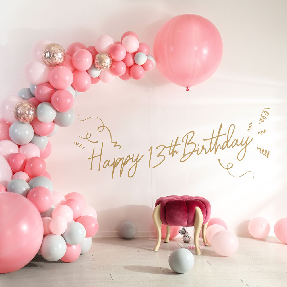 Tempaper's Custom Happy Birthday Wall Decal with "Happy 13th Birthday" as an example shown below balloons.