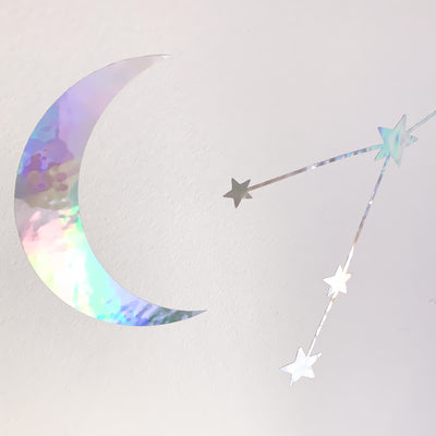 Another angle of a moon and constellation with the holographic color reflecting, from the Constellations & Moons wall decal set from Tempaper.