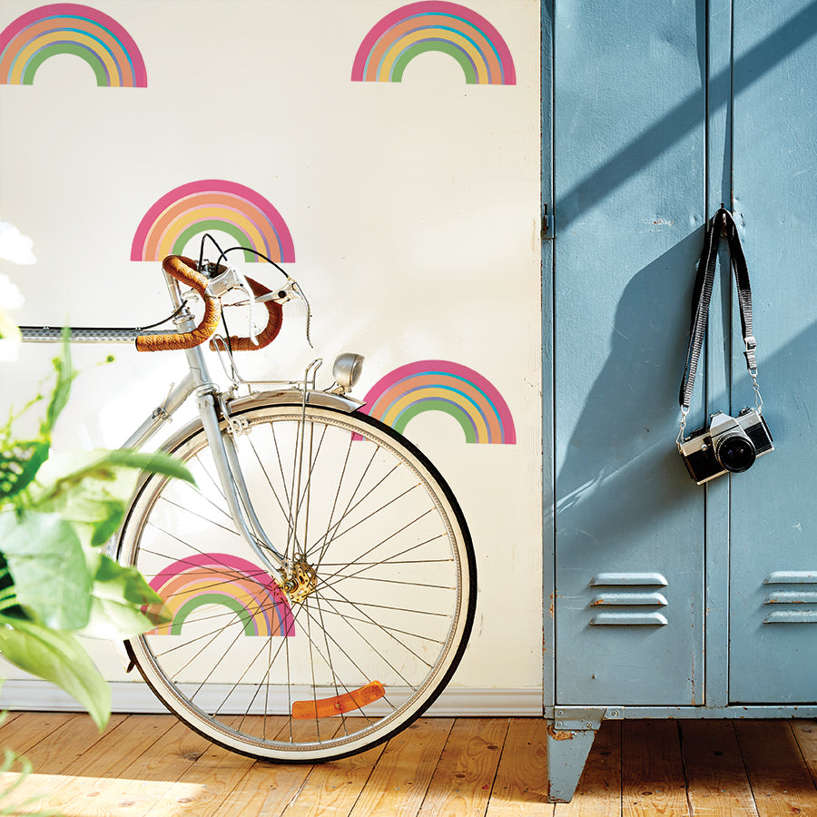 A set of lockers and a bike next to a wall accents with Rainbow wall decals from Tempaper.