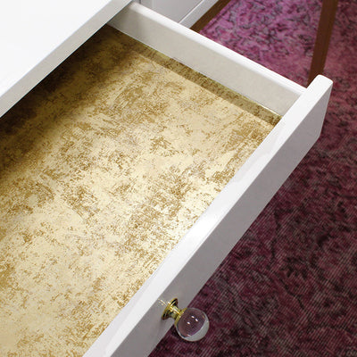 Tempaper's Distressed Gold Leaf Peel And Stick Wallpaper in metallic gold shown inside a drawer.#color_gold-leaf