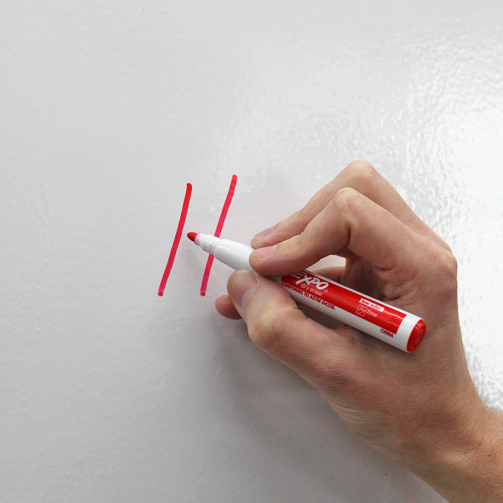 A person writing with a red Expo Dry Erase Marker.