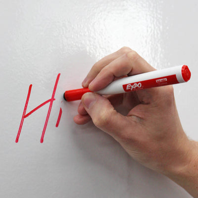 A person writing with a red Expo Dry Erase Marker.