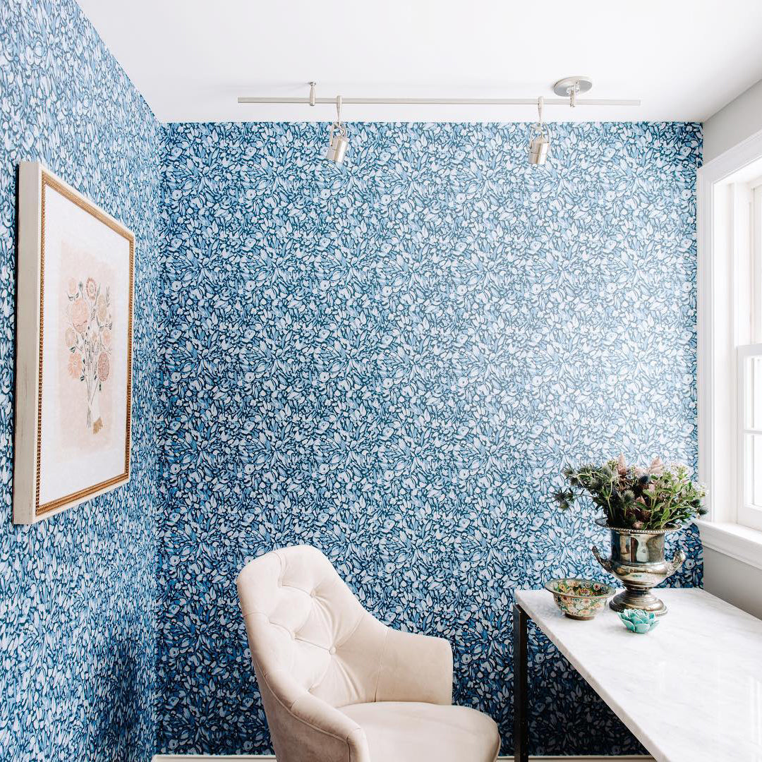 Flamboyan floral wallpaper on the wall of a home office. 