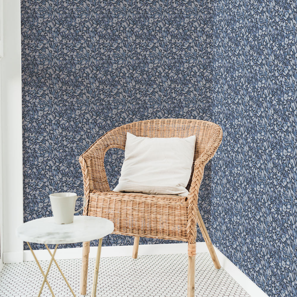Tempaper's Flamboyan Peel And Stick Wallpaper By She She shown behind a chair and table.