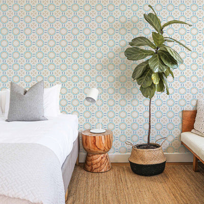 Breeze Tile peel and stick wallpaper in a bedroom displayed behind a bed.