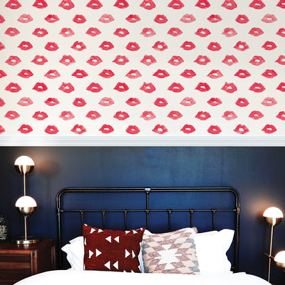Painted Lips Removable Wallpaper - A bed and wood nightstand with lamps in a bedroom featuring Painted Lips Peel And Stick Wallpaper by Novogratz | Tempaper