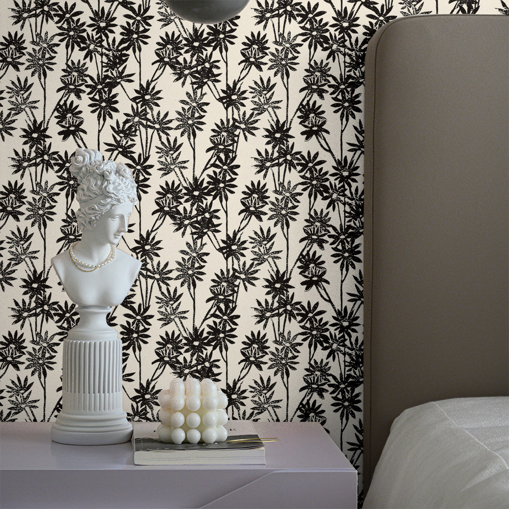 Tempaper's Daisy Bloom Peel And Stick Wallpaper By Novogratz shown behind a bed and nightstand.