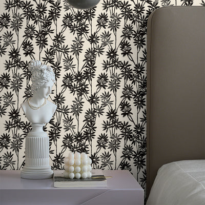 Tempaper's Daisy Bloom Peel And Stick Wallpaper By Novogratz shown behind a bed and nightstand.