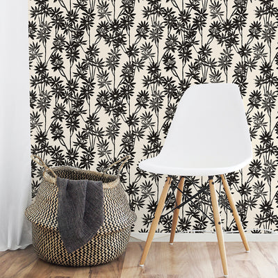 Tempaper's Daisy Bloom Peel And Stick Wallpaper By Novogratz shown behind a basket and chair.