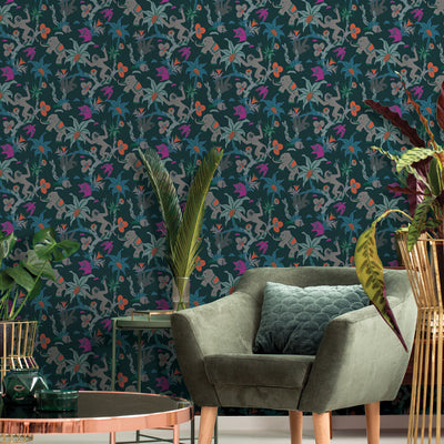 Monkey Business Removable Wallpaper - Tempaper's Monkey Business peel and stick wallpaper in passion fruit on the wall of  living room with a dark green chair, a copper coffee table, and green plants | Tempaper#color_passion-fruit
