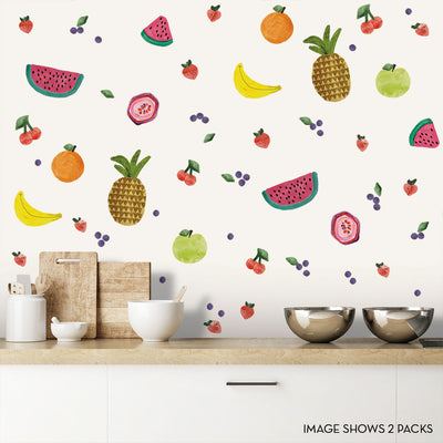 Tempaper's Fruit Salad Wall Decals shown on a wall behind bowls and cutting boards.