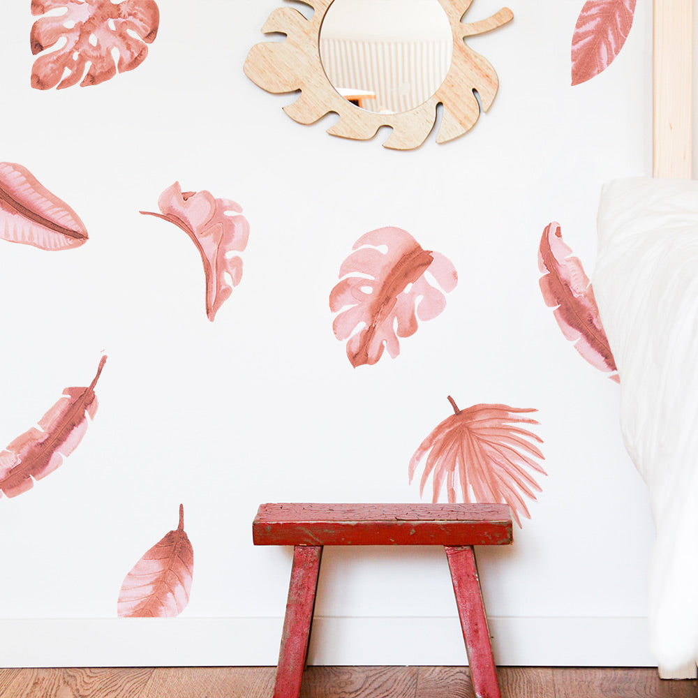 A red bench and Tempaper's Watercolor Palm Leaf Wall Decals.