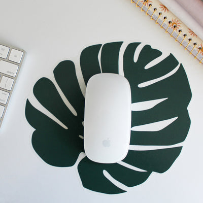 Tempaper's Graphic Palm Leaf Wall Decals on a desk underneath a computer mouse.